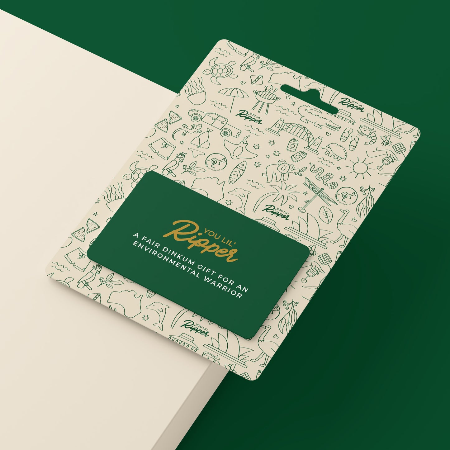 Ripper Paper gift card on a desk. Dark green card on off-white ripper branded cardboard. A gift for those who like luxurious household products that are eco-friendly.